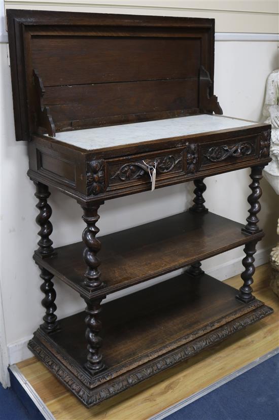 A late Victorian carved oak three tier buffet W.100cm